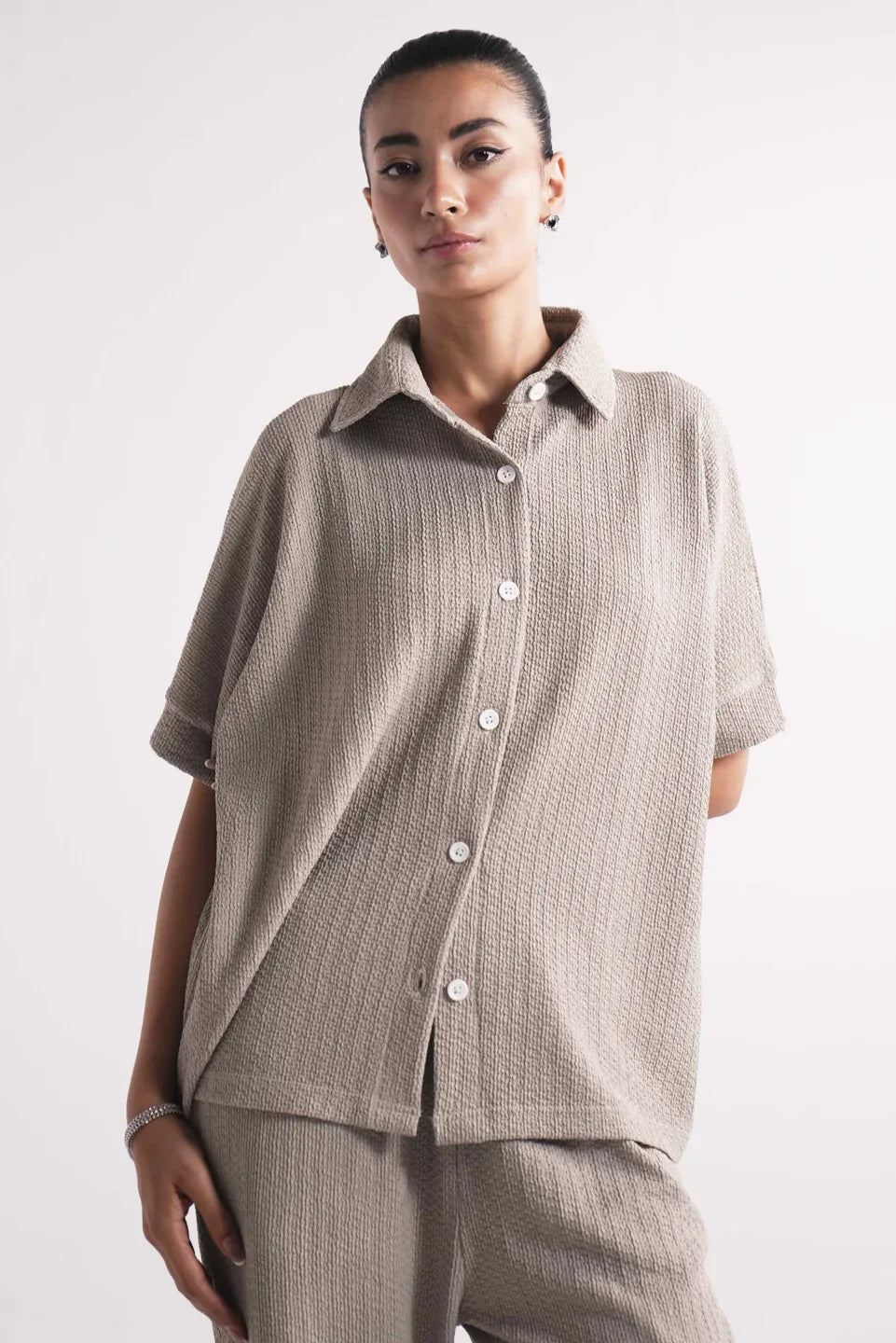 unique batwing sleeve design on beige button up shirt