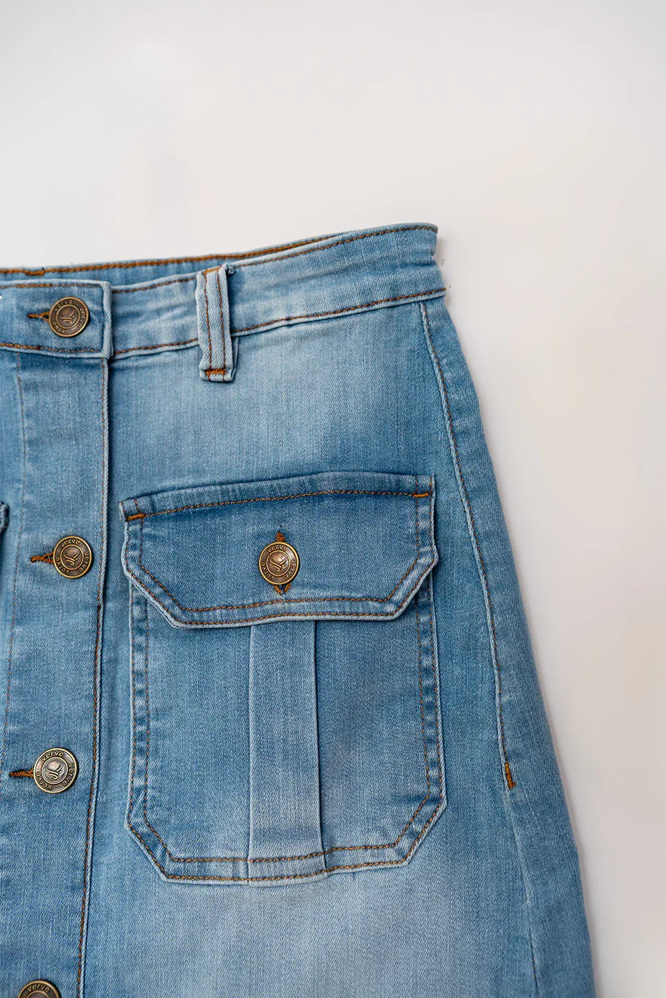 Back pocket detail of women’s light wash denim skirt