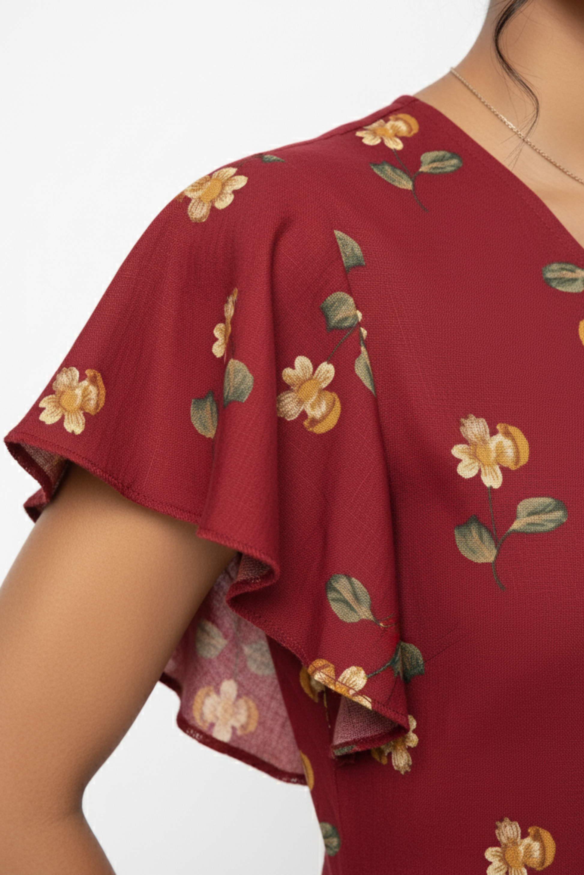 Red floral linen jumpsuit fabric close up flutter sleeves