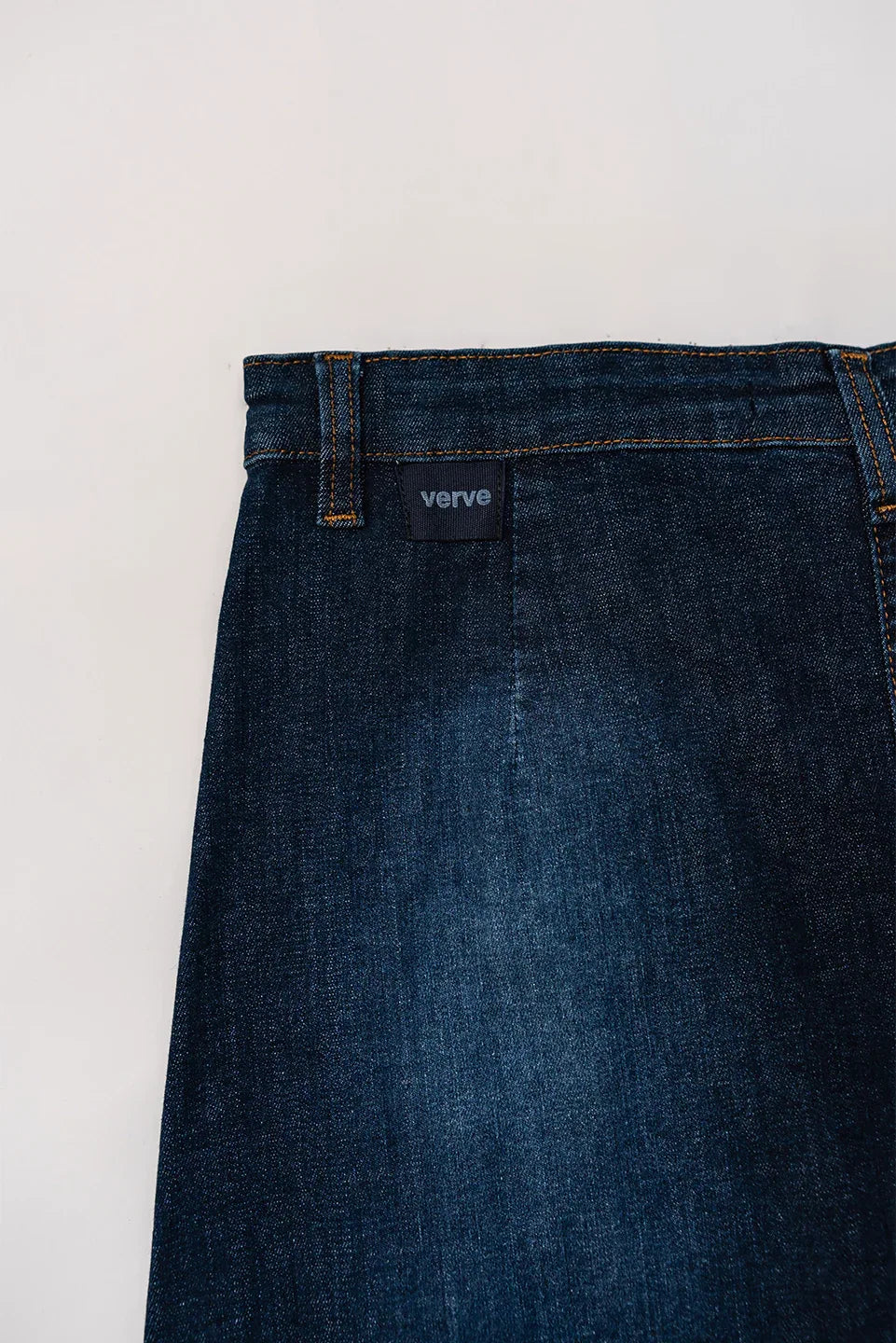 Close-up of button-down front and pockets on blue denim skirt