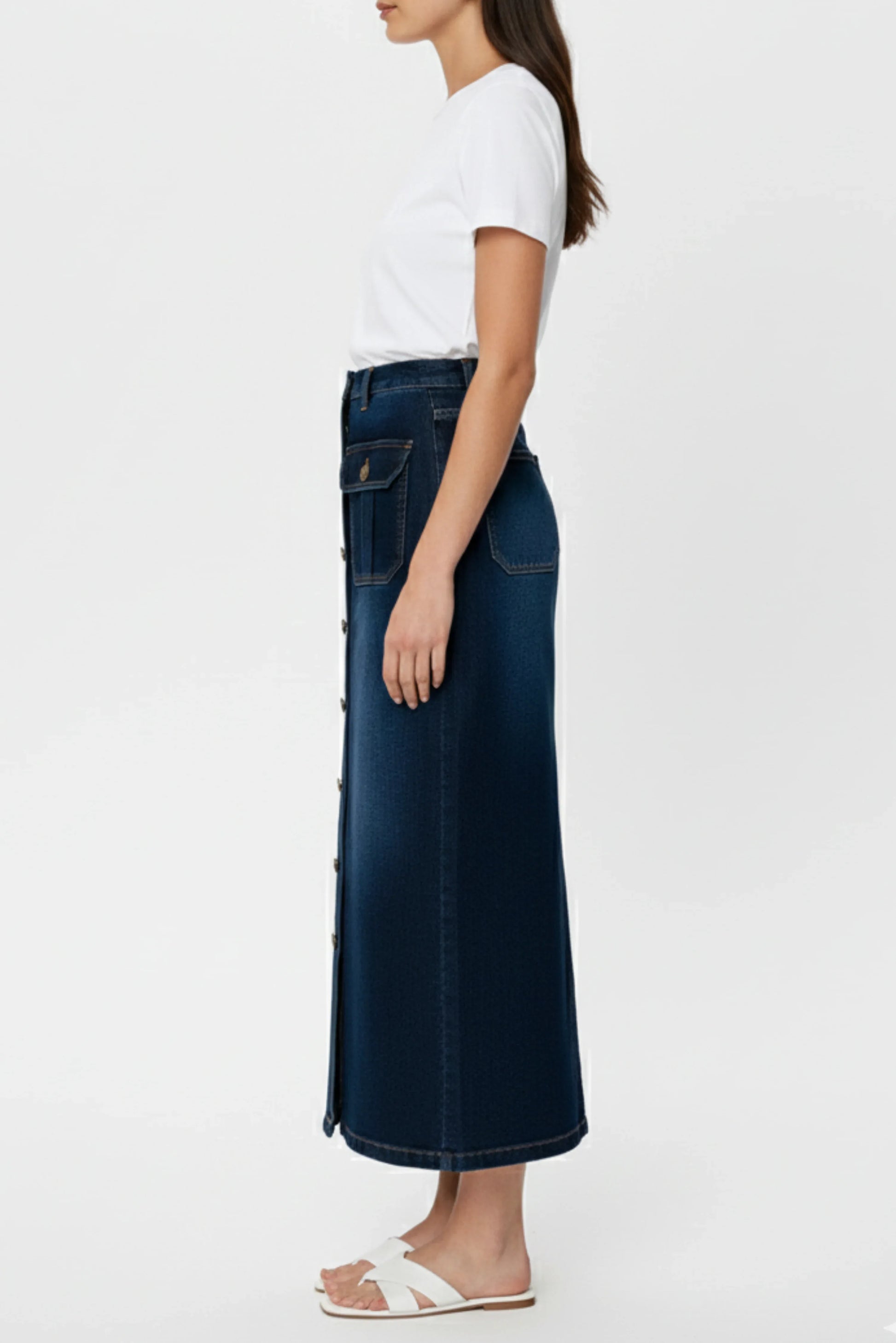 Blue button-down denim skirt, side profile of women’s casual outfit