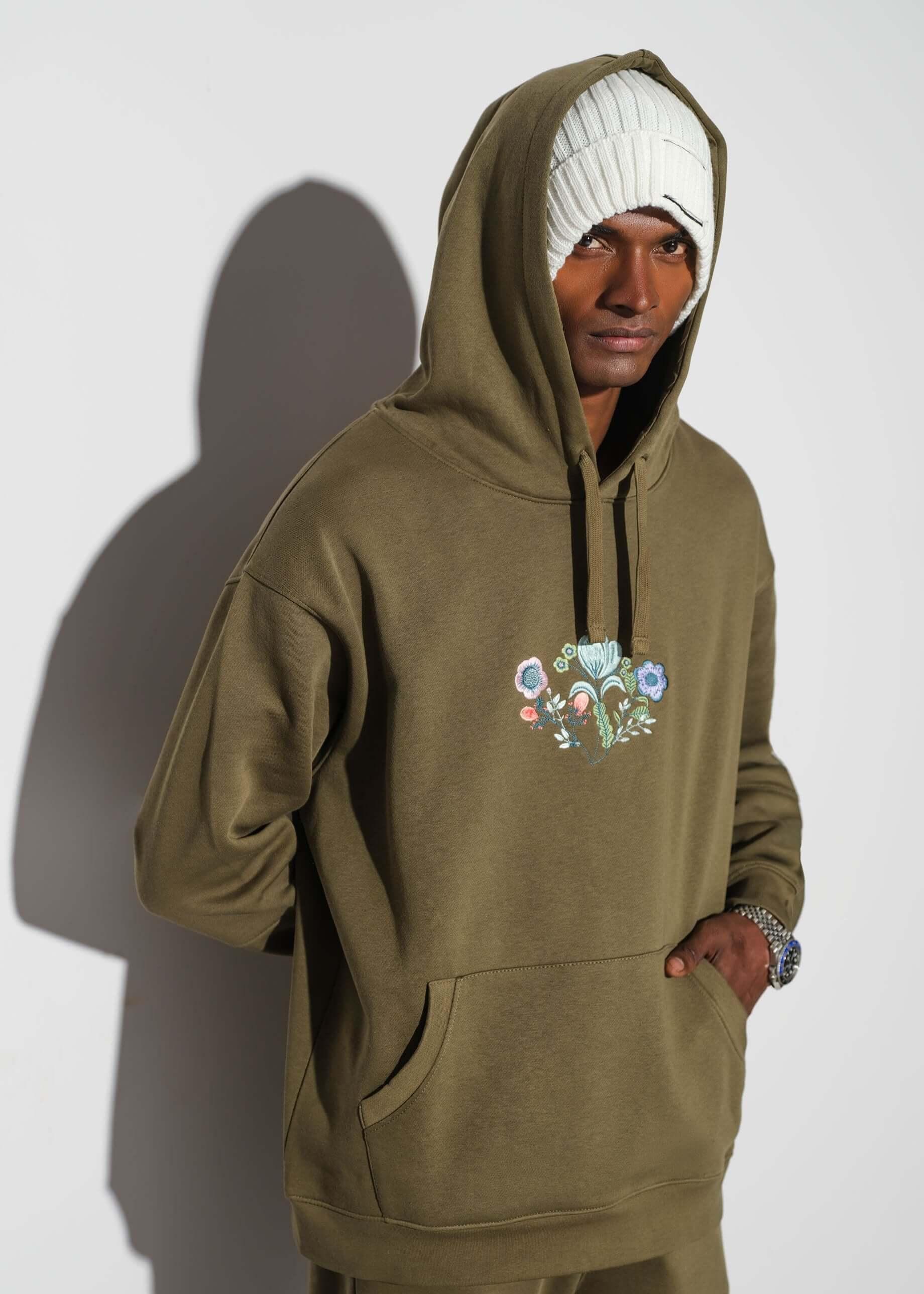 man wearing a green drop shoulder hoodie by Verve Store
