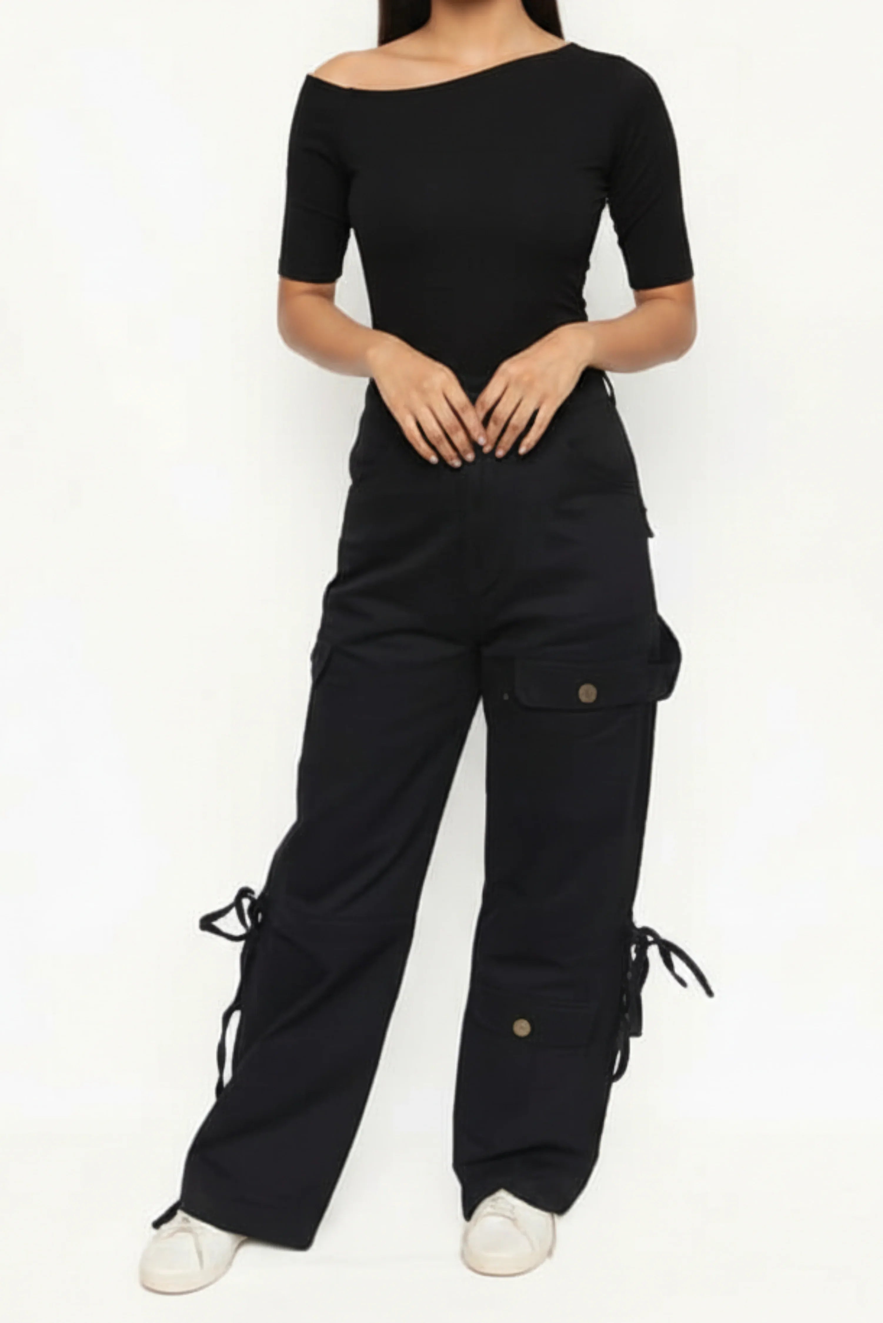 Black high-rise women's denim cargo pants with front and side pockets, paired with fitted black top, casual outfit inspiration